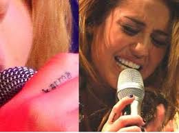 Miley Cyrus karma finger tattoo