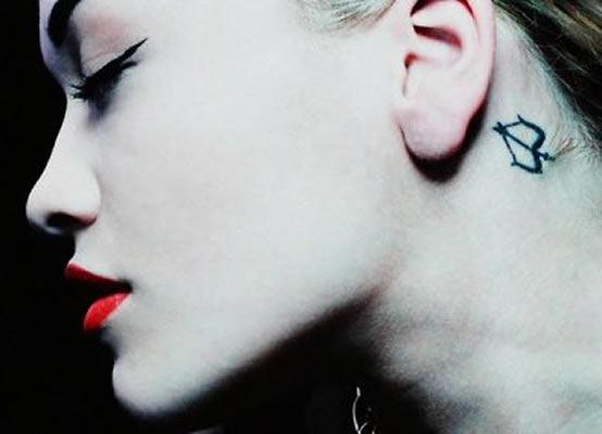 Rita Ora’s Sagittarius Tattoo Behind Her Ear