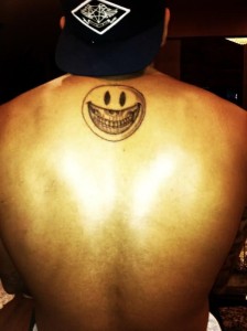 Chris Brown Back Smiley Tattoo
