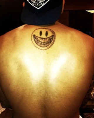 Chris Brown’s Smiley Face Skull Tattoo on His Back