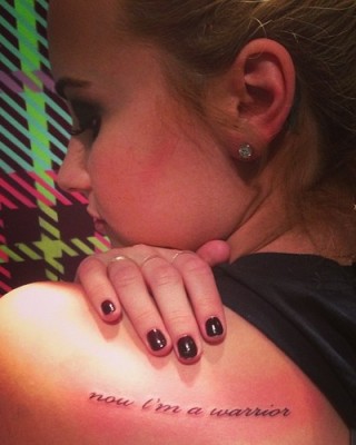 Demi Lovato’s “Now I’m a Warrior” Tattoo on Her Shoulder