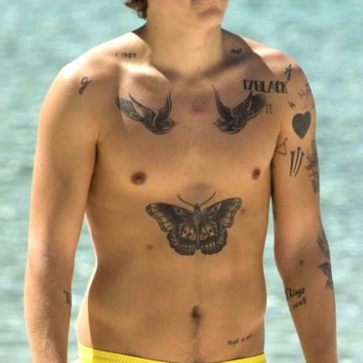 Harry Styles’ Mysterious Collarbone Tattoos – What Do 1957 and 1967 Mean??