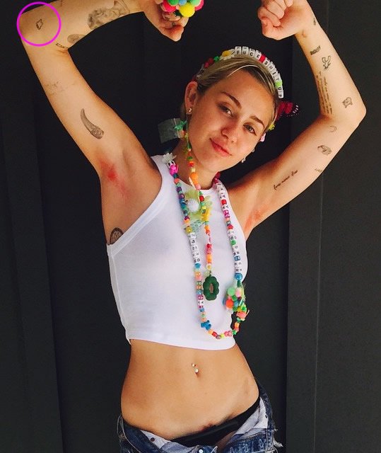 Miley Cyrus’ Little Tooth Tattoo on Her Elbow