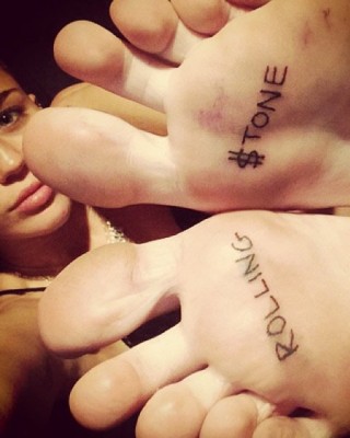 Miley Cyrus’ “Rolling $tone” Tattoos on Her Feet