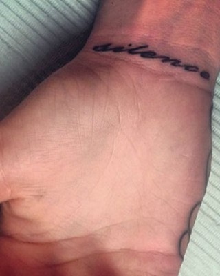 Cara Delevingne Debuts New “Silence” Wrist Tattoo