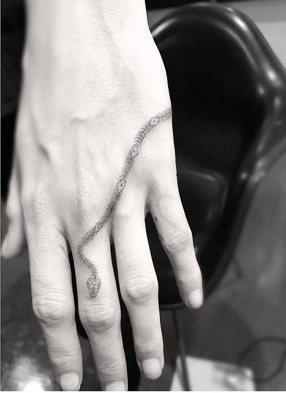 Amber Heard Designs a New Snake Skeleton Hand Tattoo for Cara Delevingne