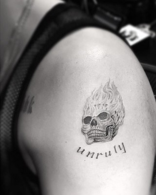 Drake’s New “Unruly” Flaming Skull Tattoo Inspired by Popcaan